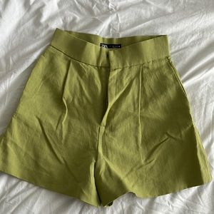 Green pleated shorts